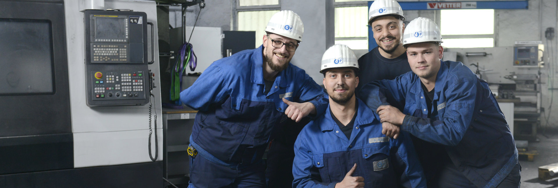 Ausbildung Siegen Gontermann-Peipers Gruppe von 4 Auszubildenden in Arbeitskleidung 